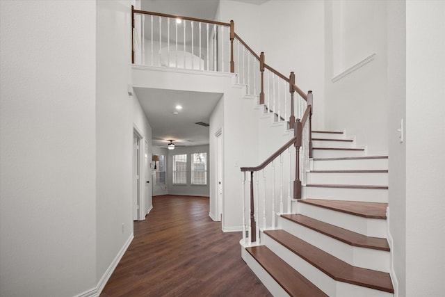 entryway featuring a high ceiling, dark hardwood / wood-style floors, and ceiling fan