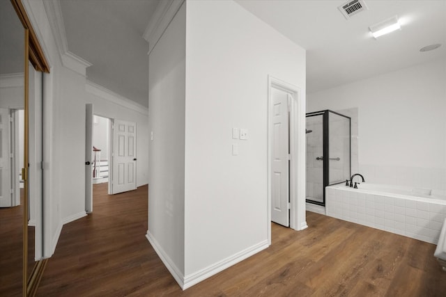 corridor featuring ornamental molding and dark hardwood / wood-style flooring