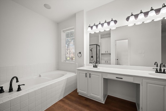 bathroom with hardwood / wood-style flooring, vanity, and independent shower and bath