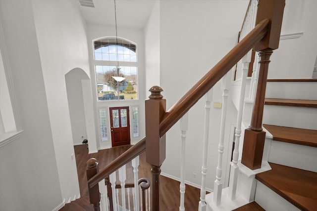 entryway featuring dark hardwood / wood-style floors and a towering ceiling