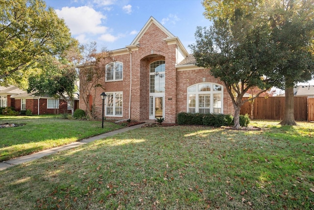 view of property featuring a front lawn