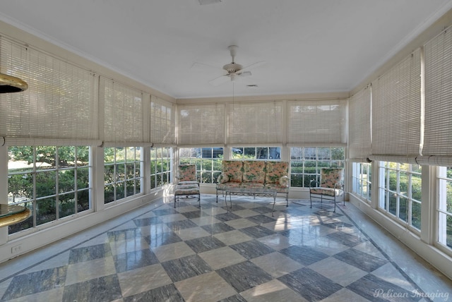 unfurnished sunroom featuring ceiling fan