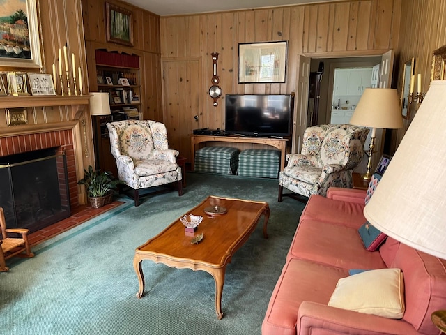 living room featuring wooden walls, a fireplace, and dark colored carpet