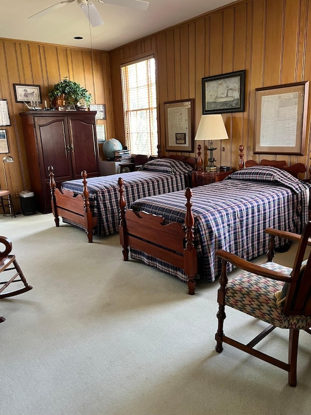 carpeted bedroom featuring wooden walls