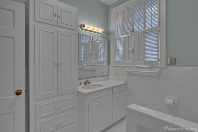 bathroom with vanity, tile walls, and ornamental molding