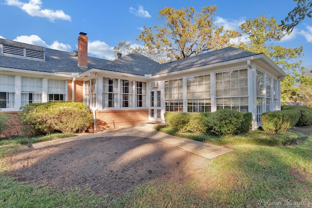 rear view of property with a sunroom