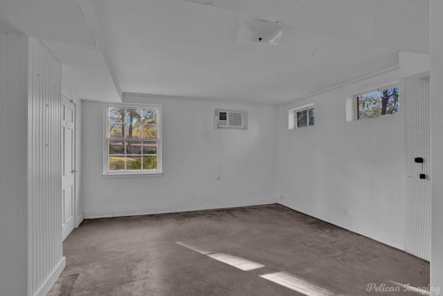 unfurnished room with concrete flooring