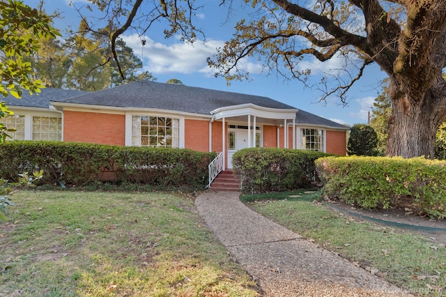 ranch-style home featuring a front yard