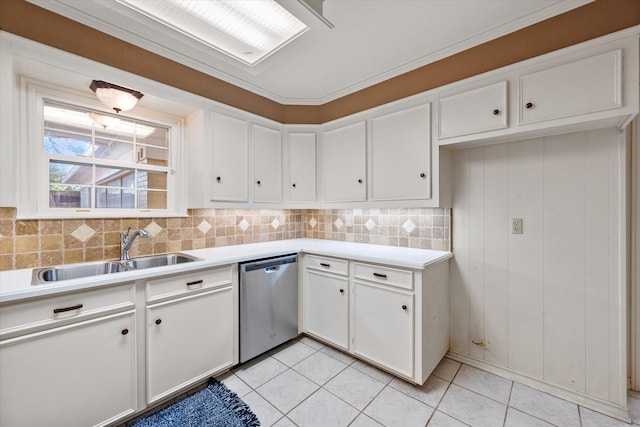 kitchen featuring stainless steel dishwasher, decorative backsplash, light countertops, white cabinets, and a sink