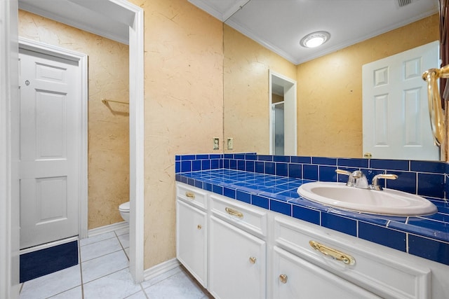 bathroom featuring vanity, ornamental molding, tile patterned floors, and toilet