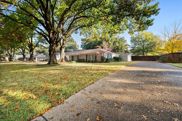 ranch-style home with a front yard