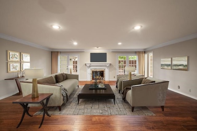 living area featuring crown molding, a fireplace, wood finished floors, baseboards, and recessed lighting
