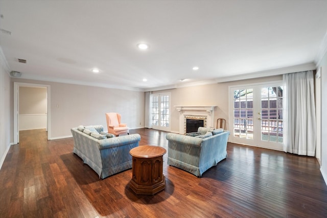 living room featuring crown molding, plenty of natural light, and dark hardwood / wood-style floors