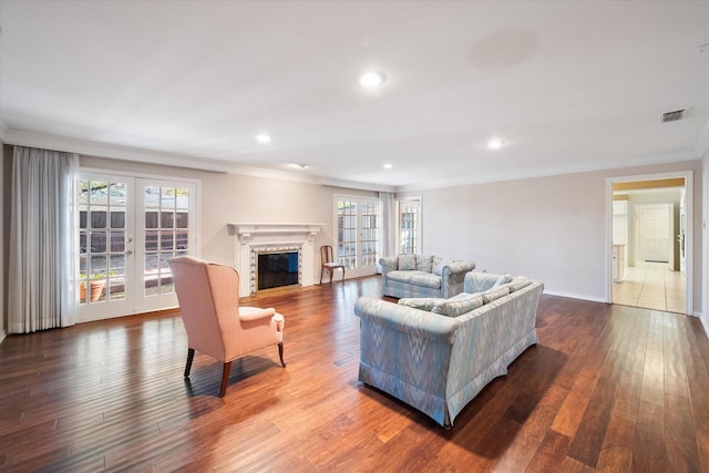 living room with french doors, ornamental molding, and hardwood / wood-style flooring