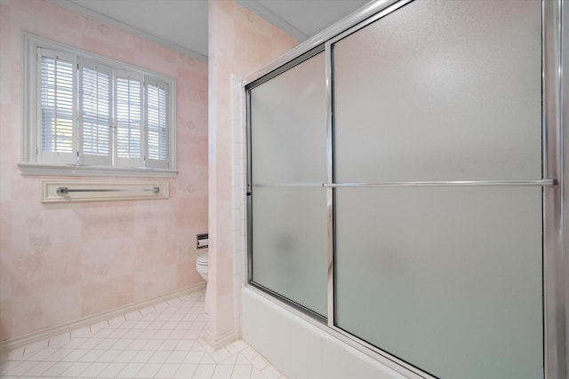 full bathroom with baseboards, shower / bath combination with glass door, tile patterned floors, and toilet