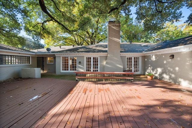 back of house with french doors, a chimney, and a deck