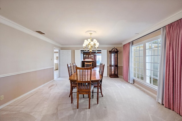 carpeted dining area with an inviting chandelier and ornamental molding