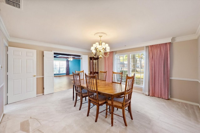 dining room featuring ornamental molding, a healthy amount of sunlight, light carpet, and a notable chandelier