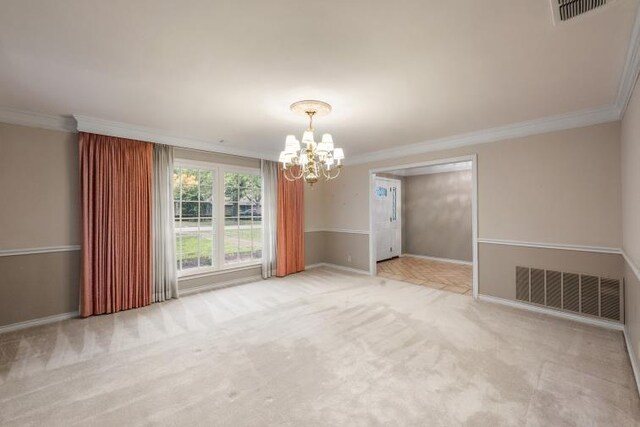 spare room featuring crown molding, carpet, a chandelier, and visible vents