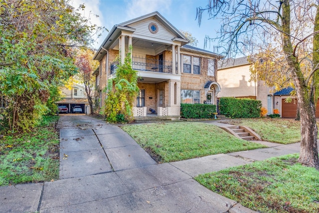 view of front of property with a balcony and a front lawn