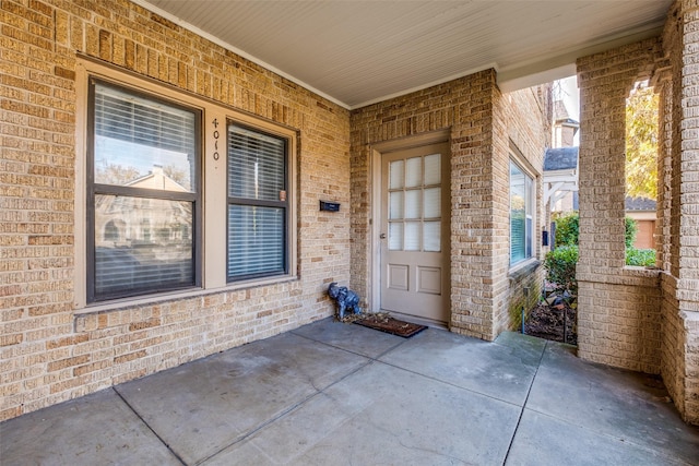 view of exterior entry featuring a patio