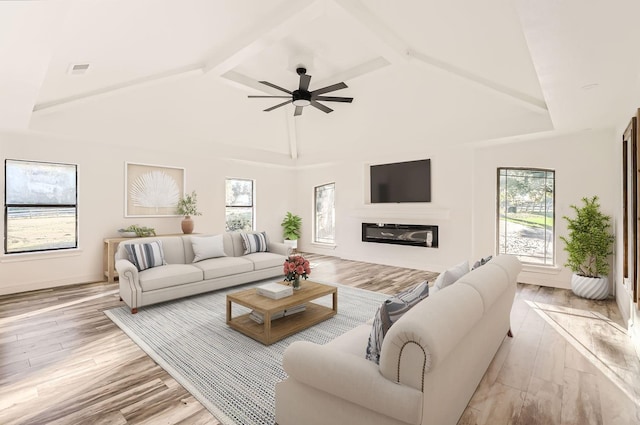 living room featuring light hardwood / wood-style floors, high vaulted ceiling, ceiling fan, and a healthy amount of sunlight