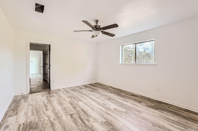 spare room with ceiling fan and light wood-type flooring