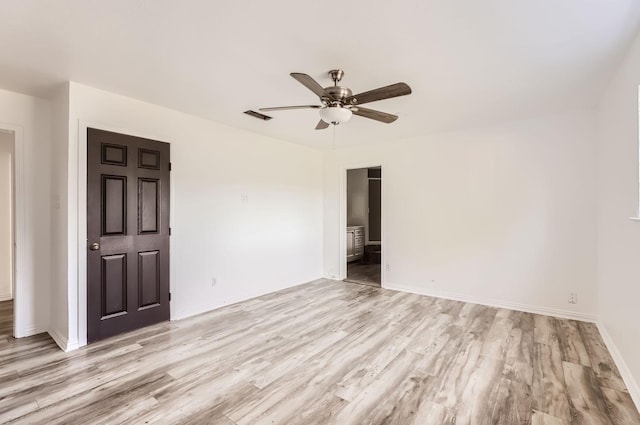 empty room featuring ceiling fan and light hardwood / wood-style floors