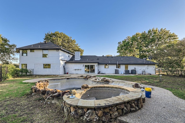 rear view of property featuring a yard