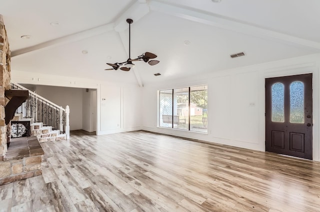 unfurnished living room featuring ceiling fan, light hardwood / wood-style flooring, beamed ceiling, and high vaulted ceiling