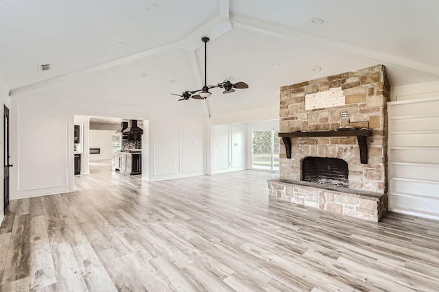 unfurnished living room with hardwood / wood-style floors, ceiling fan, a fireplace, and high vaulted ceiling