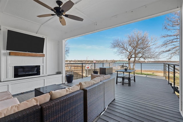 deck with an outdoor hangout area, a water view, and ceiling fan