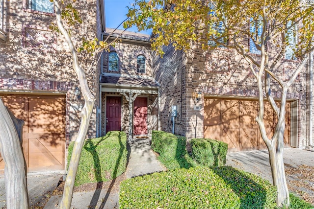 341 Metropolitan Dr, Plano, TX 75023 - view of front of house with brick siding, driveway, and an attached garage
