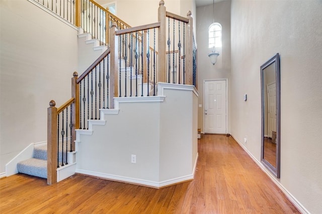 341 Metropolitan Dr, Plano, TX 75023 - staircase featuring a towering ceiling and wood finished floors