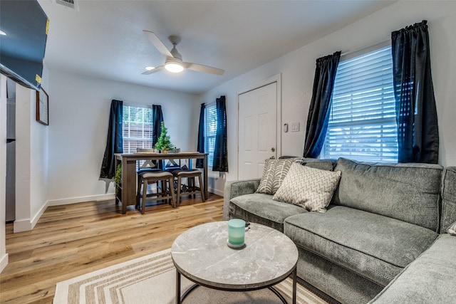 living room with wood-type flooring and ceiling fan