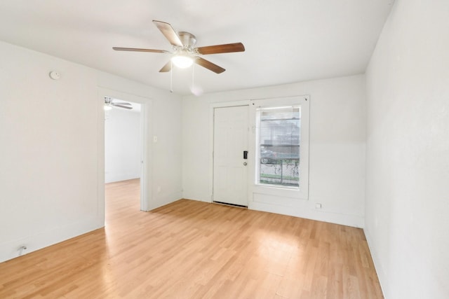 spare room featuring light wood-type flooring and a ceiling fan