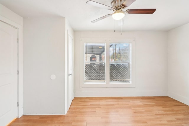 unfurnished room with light wood-type flooring and ceiling fan