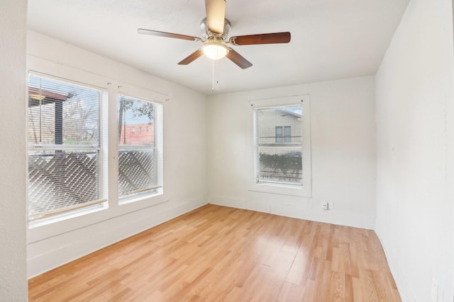 empty room with light wood-style floors and a ceiling fan