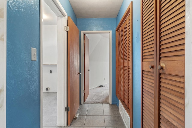 hallway with light tile patterned floors