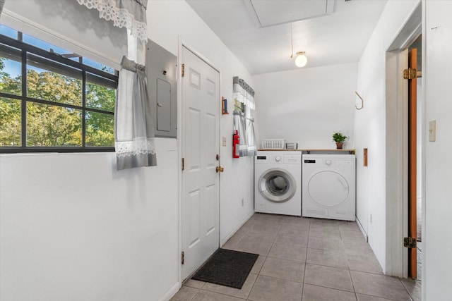 laundry room with washer and dryer, light tile patterned floors, and electric panel