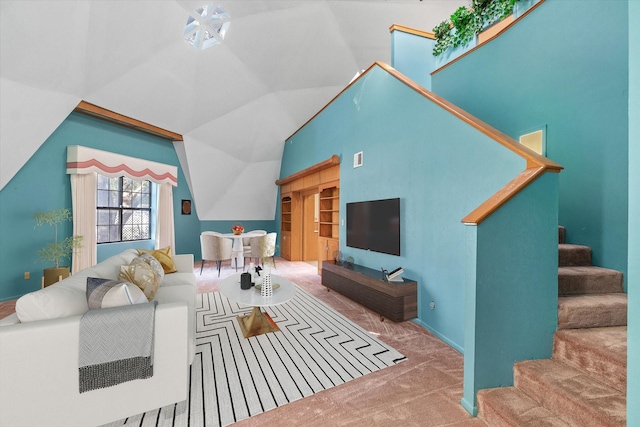 living room with lofted ceiling and carpet flooring