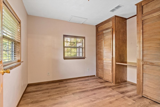 unfurnished bedroom featuring a closet and light hardwood / wood-style flooring