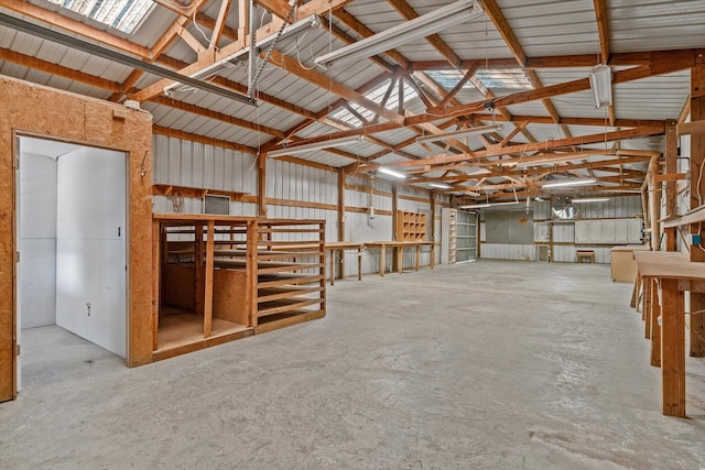 interior space with concrete flooring and vaulted ceiling