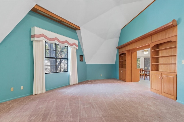 bonus room with light carpet, ceiling fan, and lofted ceiling