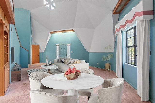 dining area featuring vaulted ceiling and carpet flooring