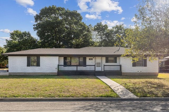 ranch-style home with a front yard and a porch