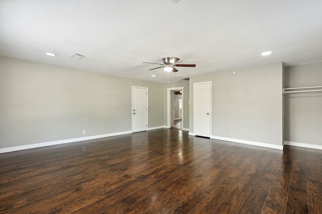 spare room featuring dark wood-type flooring and ceiling fan