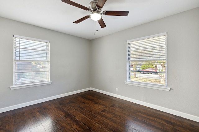 unfurnished room featuring ceiling fan, a healthy amount of sunlight, and dark hardwood / wood-style floors