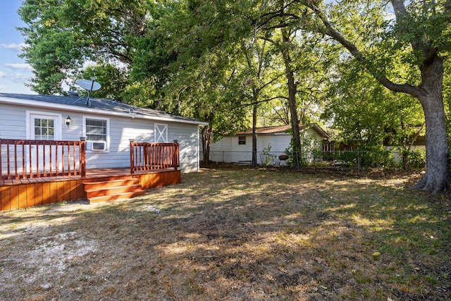 view of yard with cooling unit and a deck