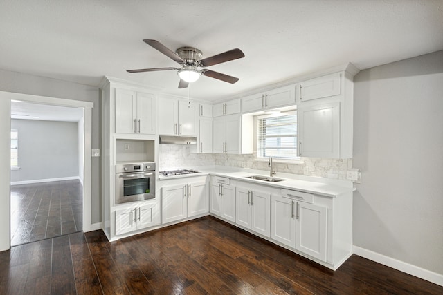 kitchen featuring sink, decorative backsplash, white cabinets, and appliances with stainless steel finishes